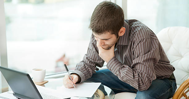 man filling out forms