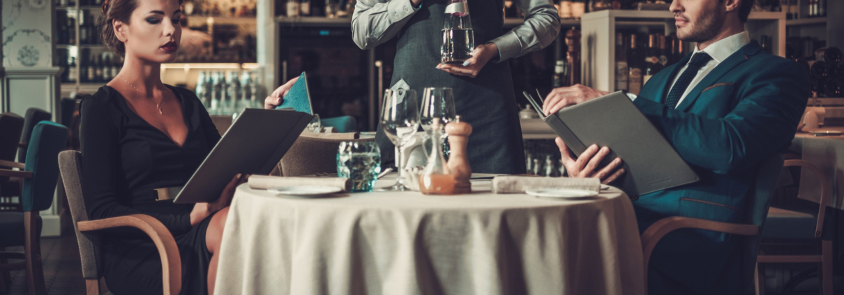 couple reading menu in a restaurant PVTFHPX