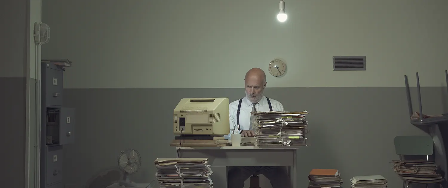 businessman overloaded with paperwork 1500x630 1