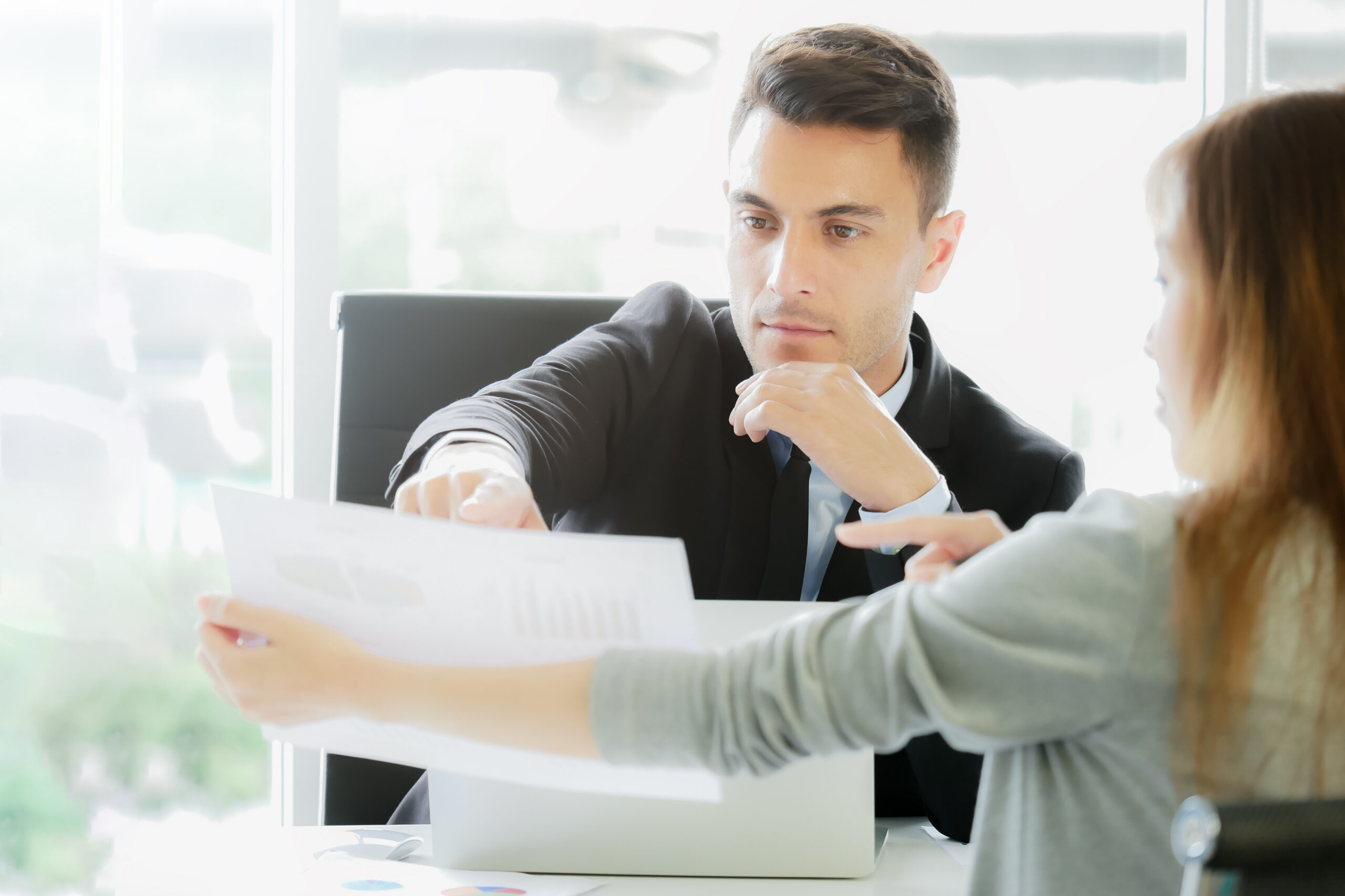 financial report analysis and reviewing concept :cfo or chief financial officer sees financial summary reports with his secretary and discusses about future growth and improvements